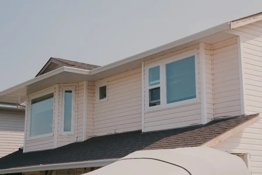 New white windows installed on an Alberta home with vinyl siding